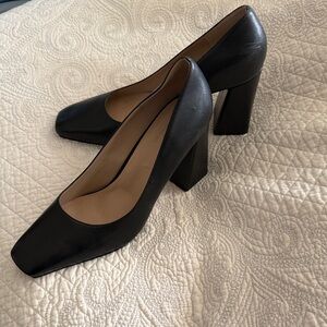 Elegant black block heel pumps.